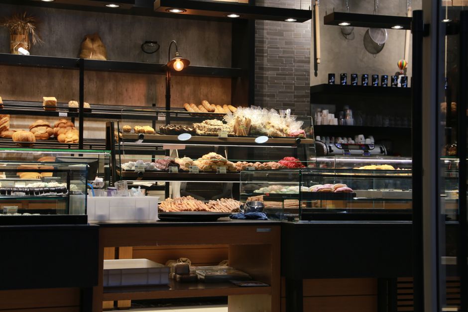 Inviting bakery interior showcasing a variety of fresh breads and pastries on display in a warm setting.